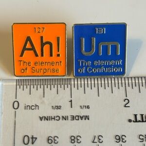 Blue ‘Um’ The element of Confusion and Orange 'Ah! The Element of Surprise' Pins